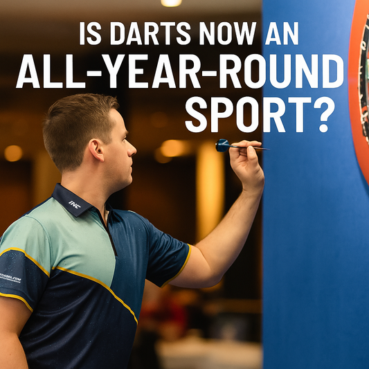 Darts player in a blue and turquoise custom shirt preparing to throw, standing beside a dartboard with the text 'Is Darts Now an All-Year-Round Sport? | INC-APPAREL