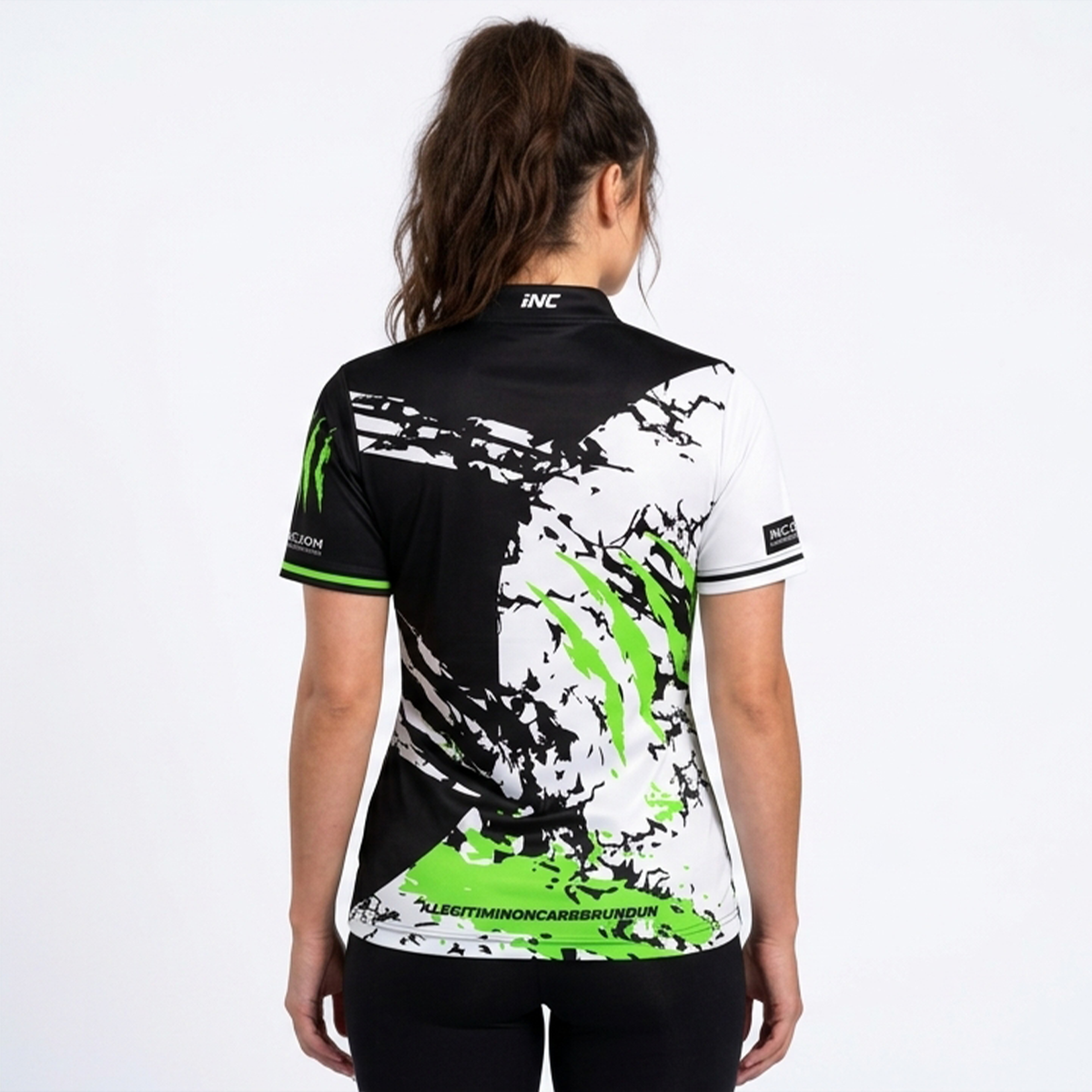 Back view of the Alpha Women's Black White and Green Darts Shirt, highlighting the breathable contoured back paneling and flexible shoulder construction for unrestricted movement.