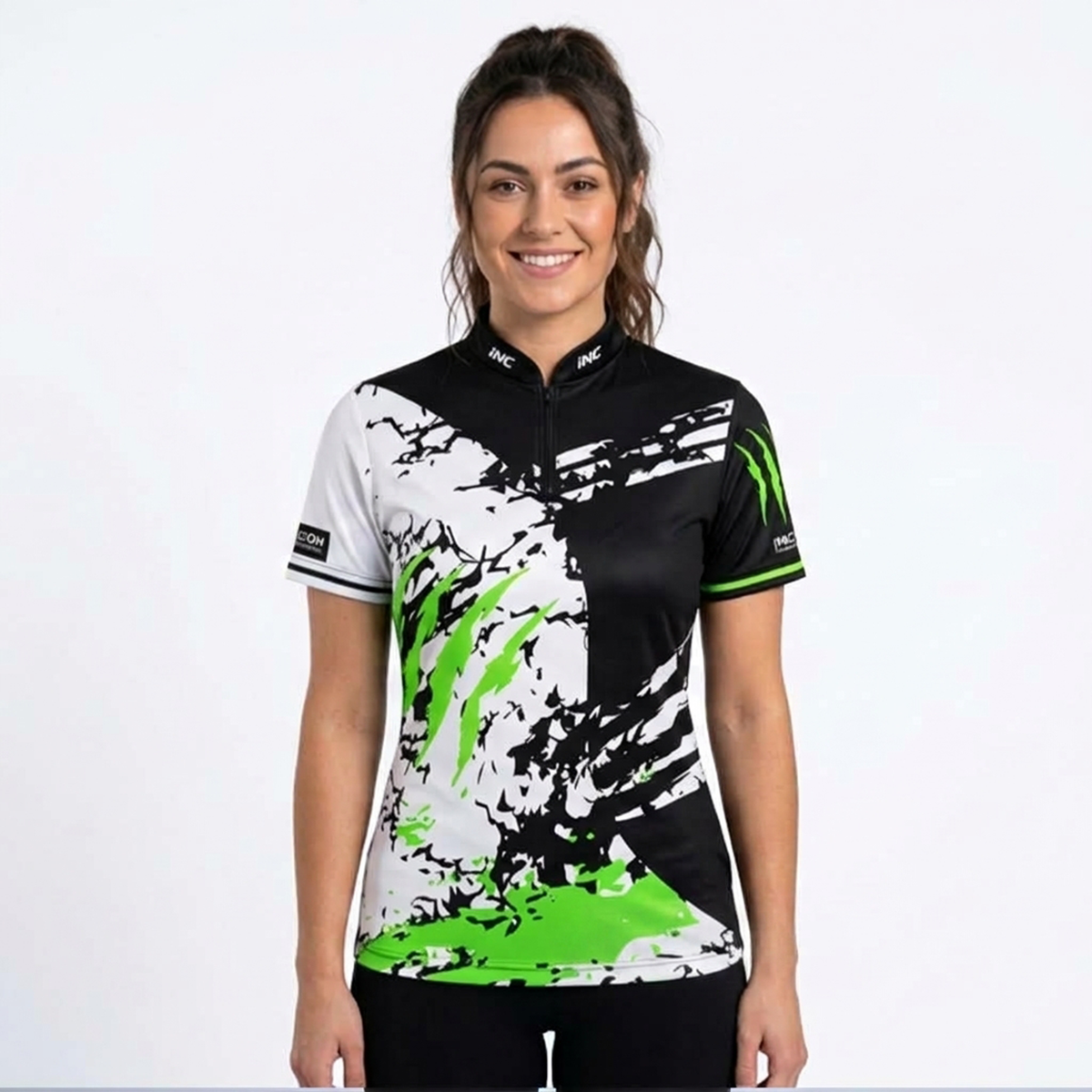 Front view of the Alpha Women's Black White and Green Darts Shirt, showcasing the bold scratch panel design, tailored feminine silhouette, structured collar, and Controlled Climate hem logo.