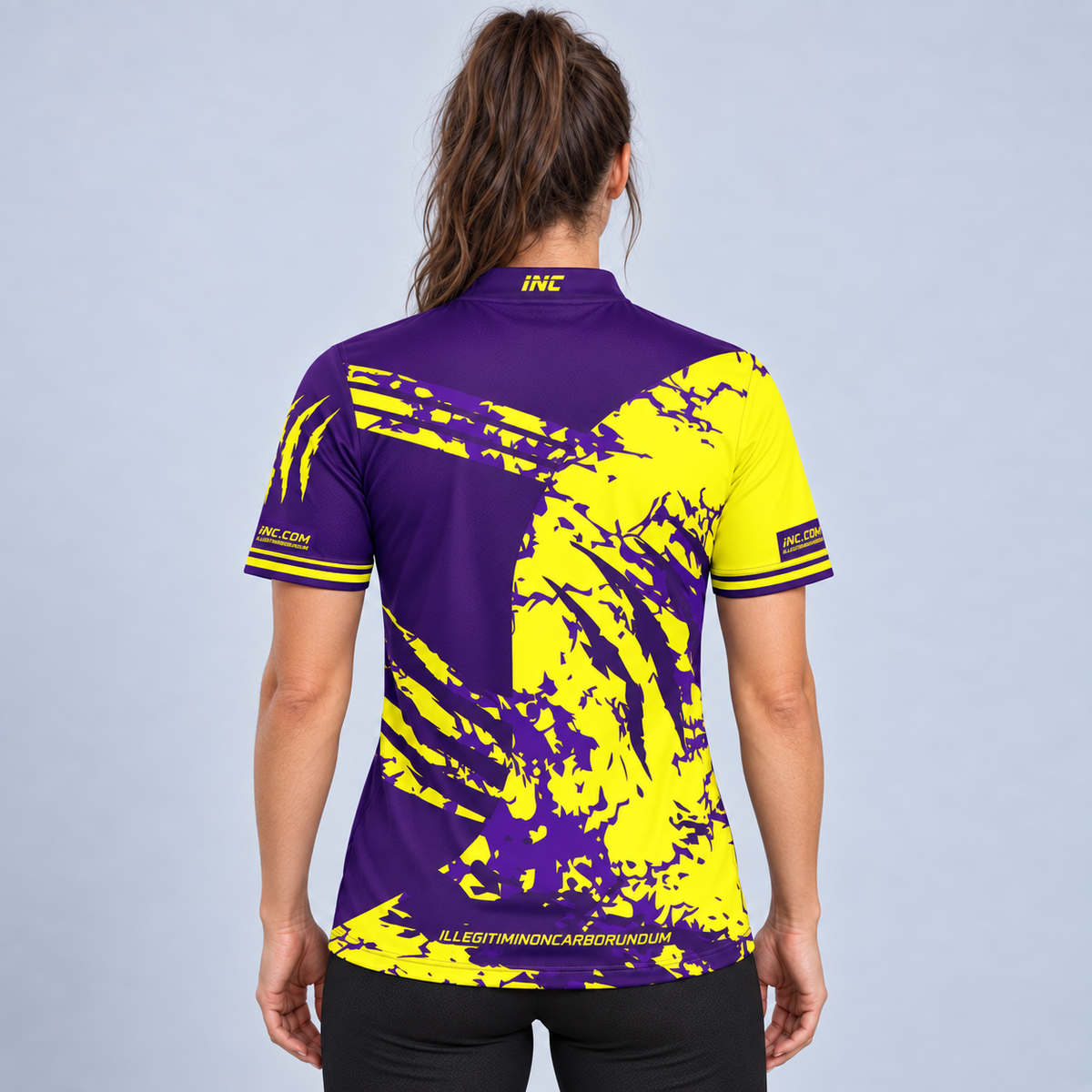 Back view of the Alpha Women's Purple and Yellow Shirt, highlighting the breathable contoured back paneling and flexible shoulder construction for unrestricted movement.