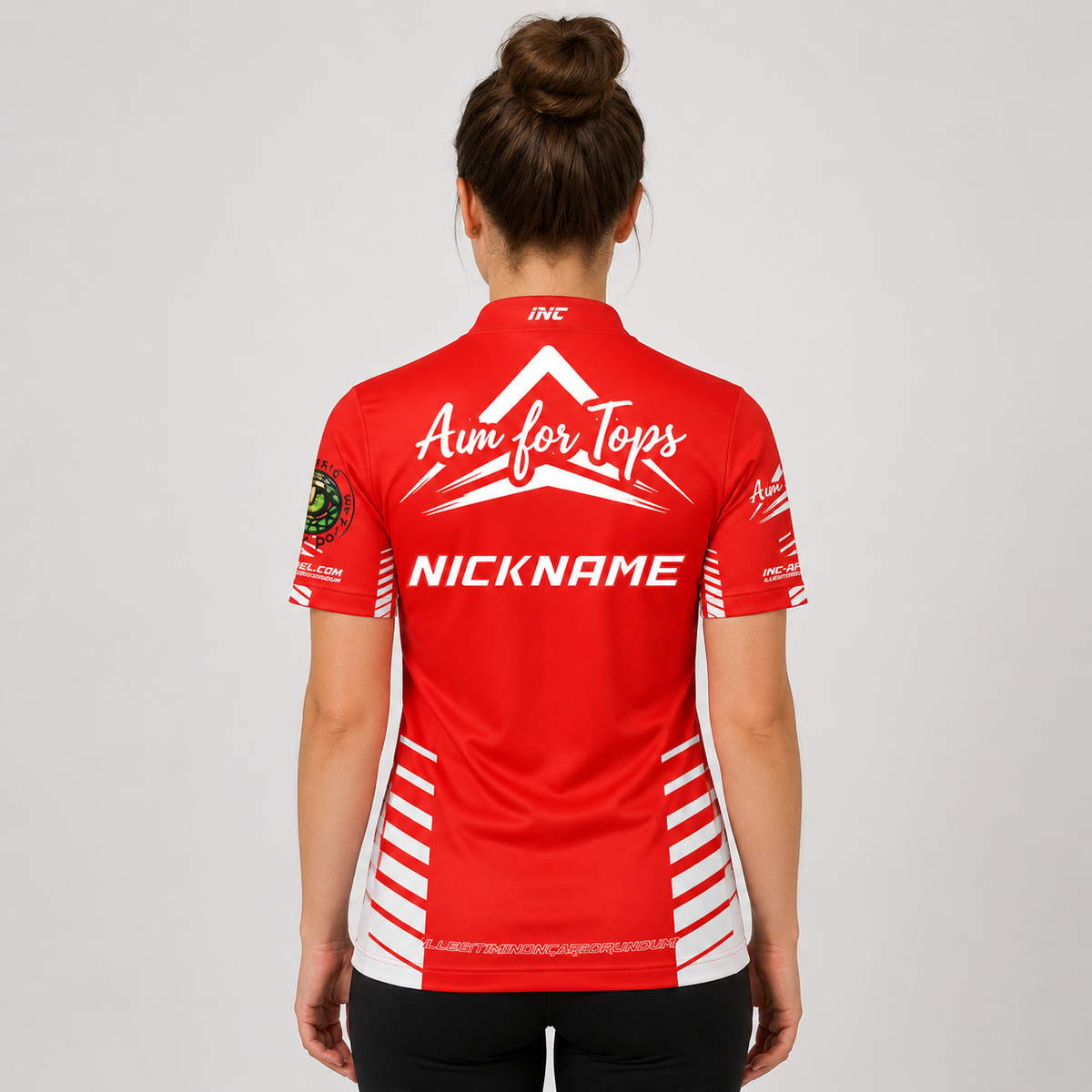 Back view of the Official Aim For Tops Women's Darts Shirt, showcasing the breathable contoured back paneling and flexible sleeve cut for smooth throwing motion.