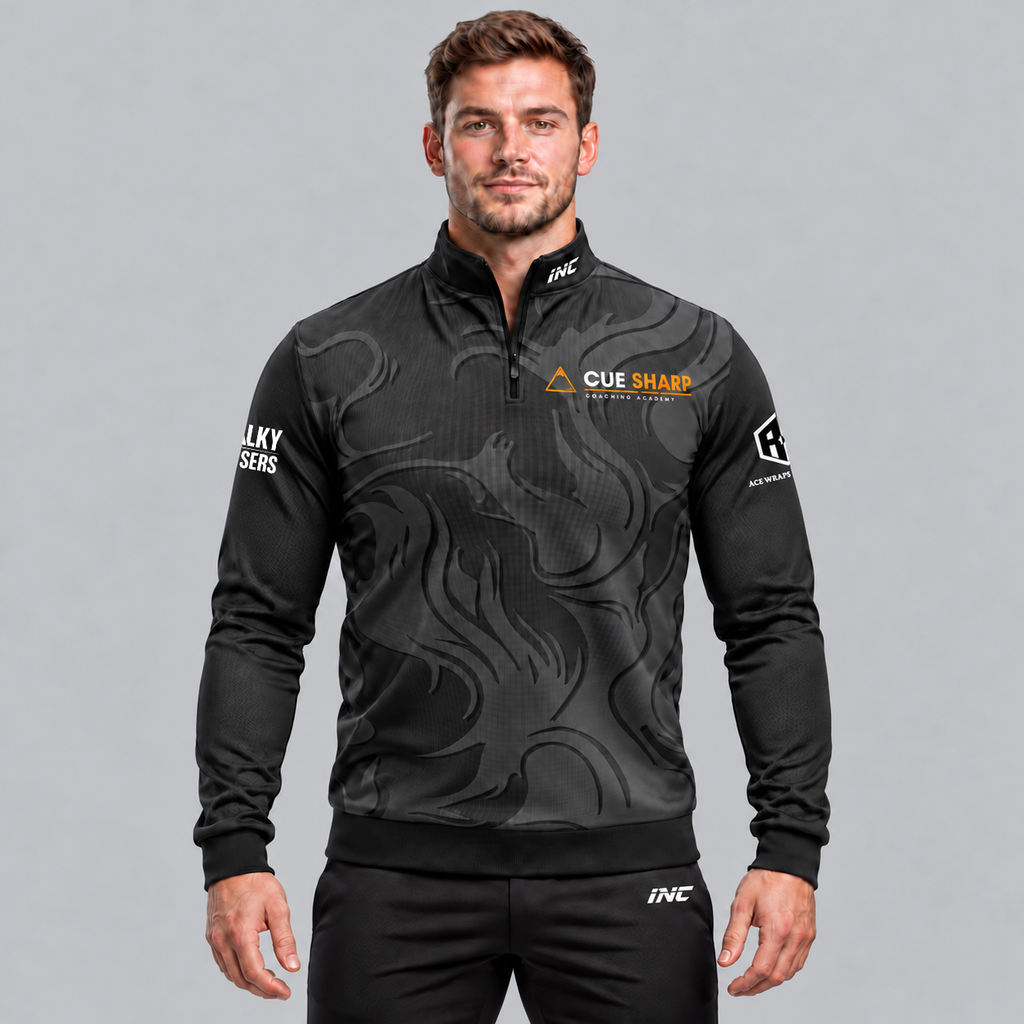 Front view of the Official Cue Sharp Coaching Unisex Quarter Zip Midlayer, displaying dark charcoal fabric with gold accents, quarter-zip stand collar, official Cue Sharp chest logo, and Controlled Climate hem detail.