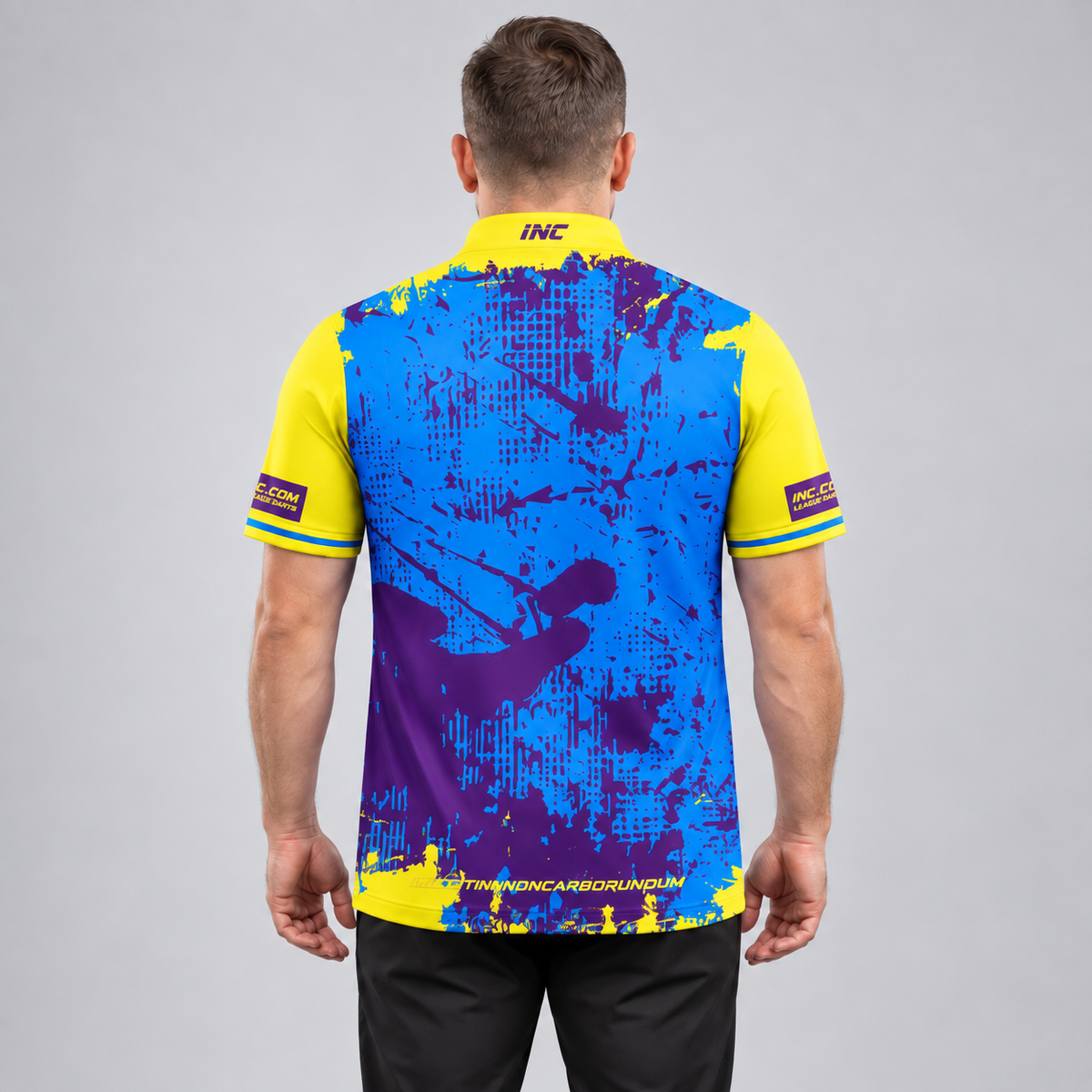 Back view of the Daemon Men and Youth Yellow and Purple Darts Shirt, highlighting the breathable rear paneling and flexible shoulder construction for unrestricted movement.