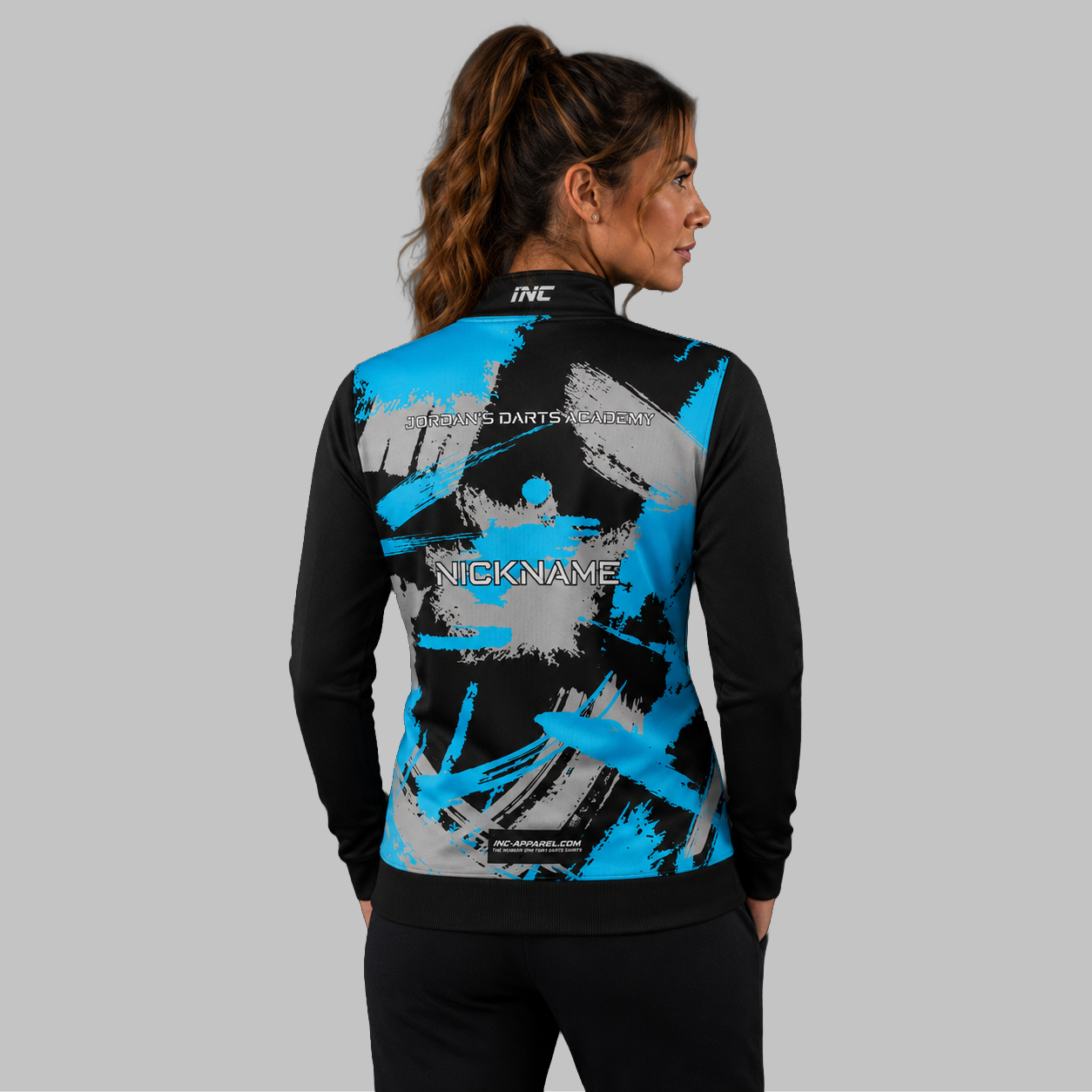 Back view of the unisex Jordan's Darts Academy Quarter Zip Midlayer, showcasing the clean athletic silhouette and flexible shoulder construction.
