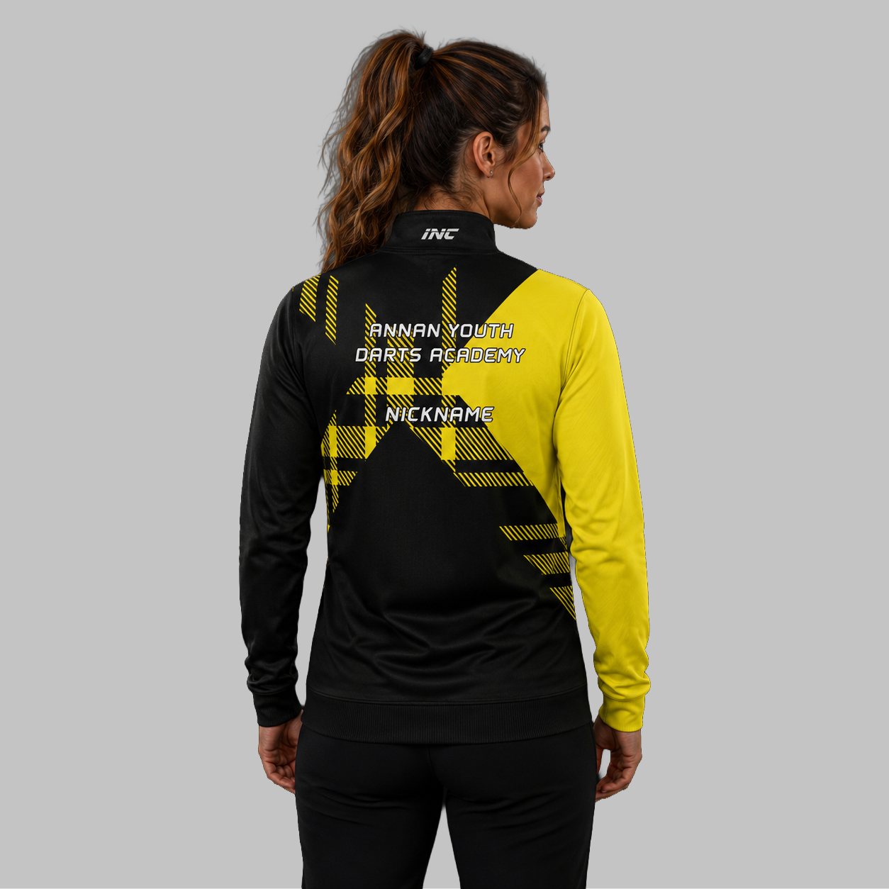 Back view of the unisex Official Annan Youth Darts Academy Quarter Zip Midlayer, showing the clean athletic silhouette and flexible shoulder construction.