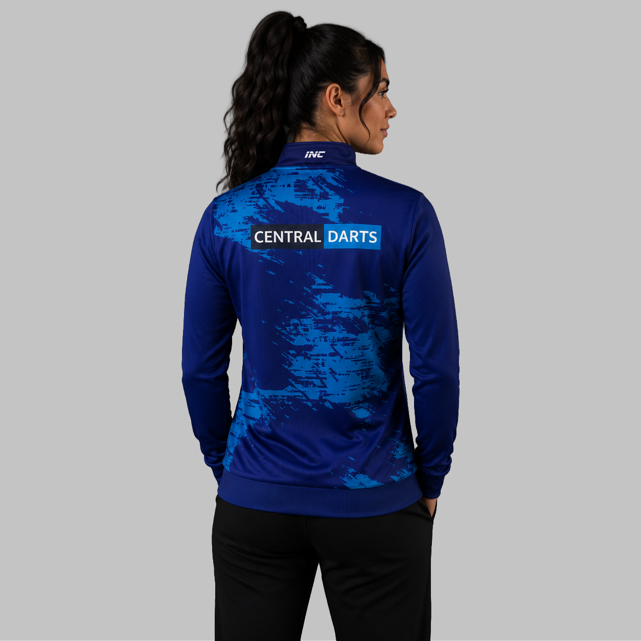 Back view of the unisex Official Central Darts League Academy Quarter Zip Midlayer, showing the clean athletic silhouette and flexible shoulder construction.