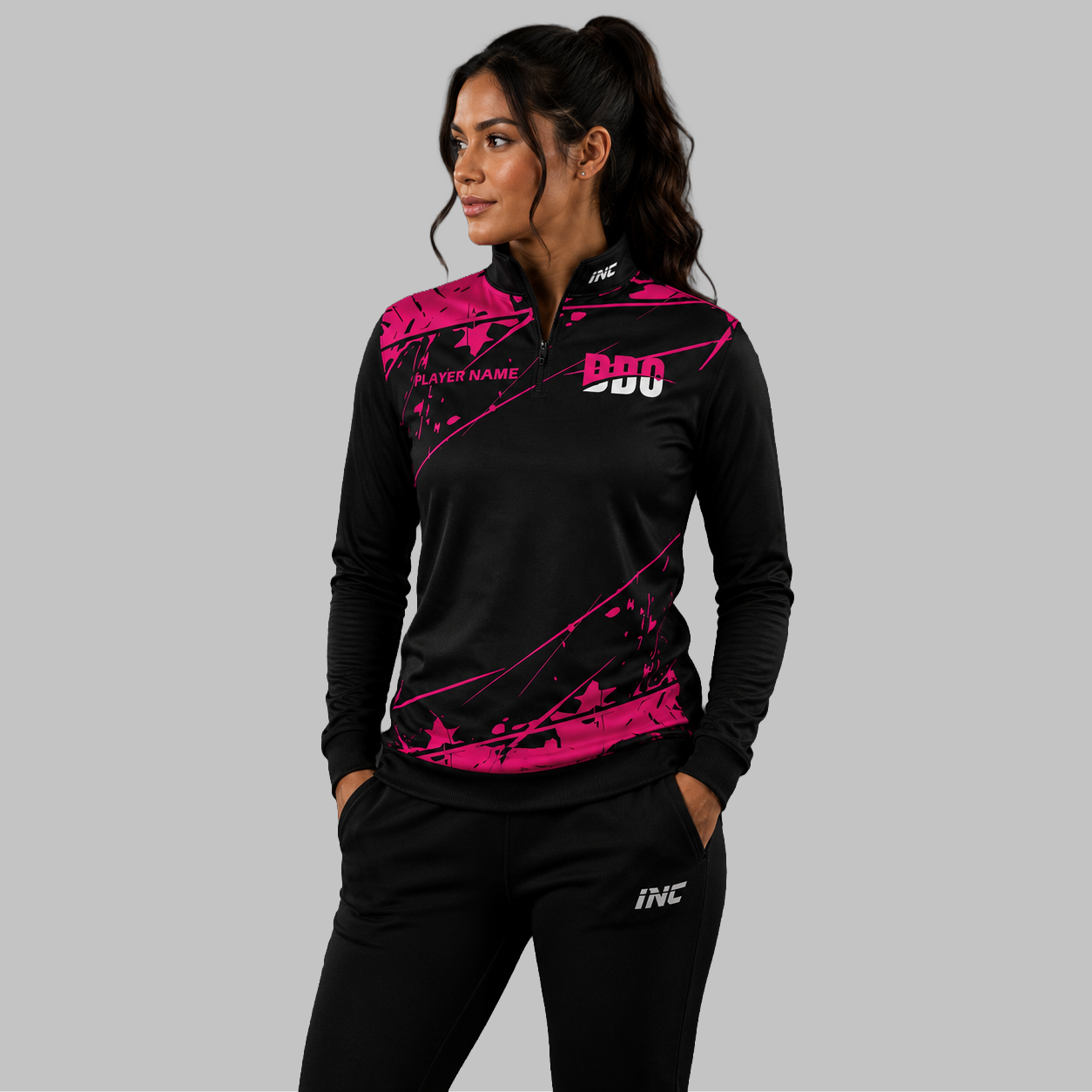 Front view of the unisex Official Deaf Darts Organisation Pink Quarter Zip Midlayer, highlighting the athletic pullover design, stand-up collar, and official DDO branding.