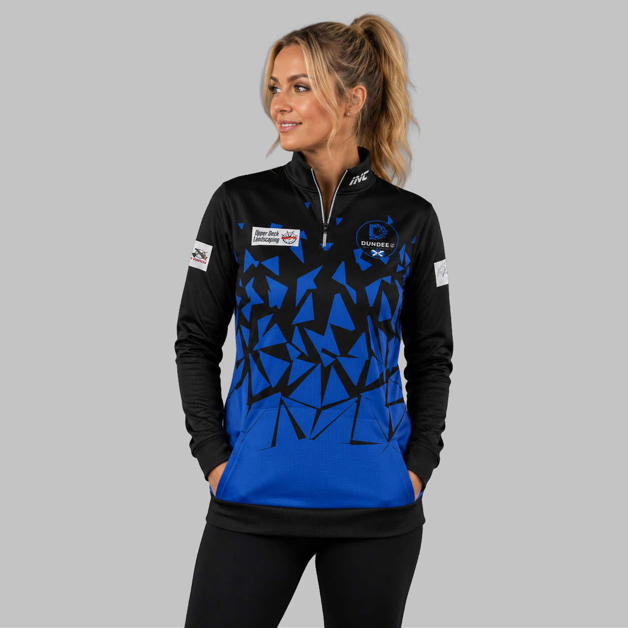 Front view of the unisex Official Dundee Darts Academy Quarter Zip Midlayer, highlighting the athletic pullover design, stand-up collar, and official academy branding.
