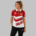 Front view of the Women's Official JDC England Zip Polo Darts Shirt, showing the custom-contoured athletic fit, quarter-zip collar, and prominent team branding.