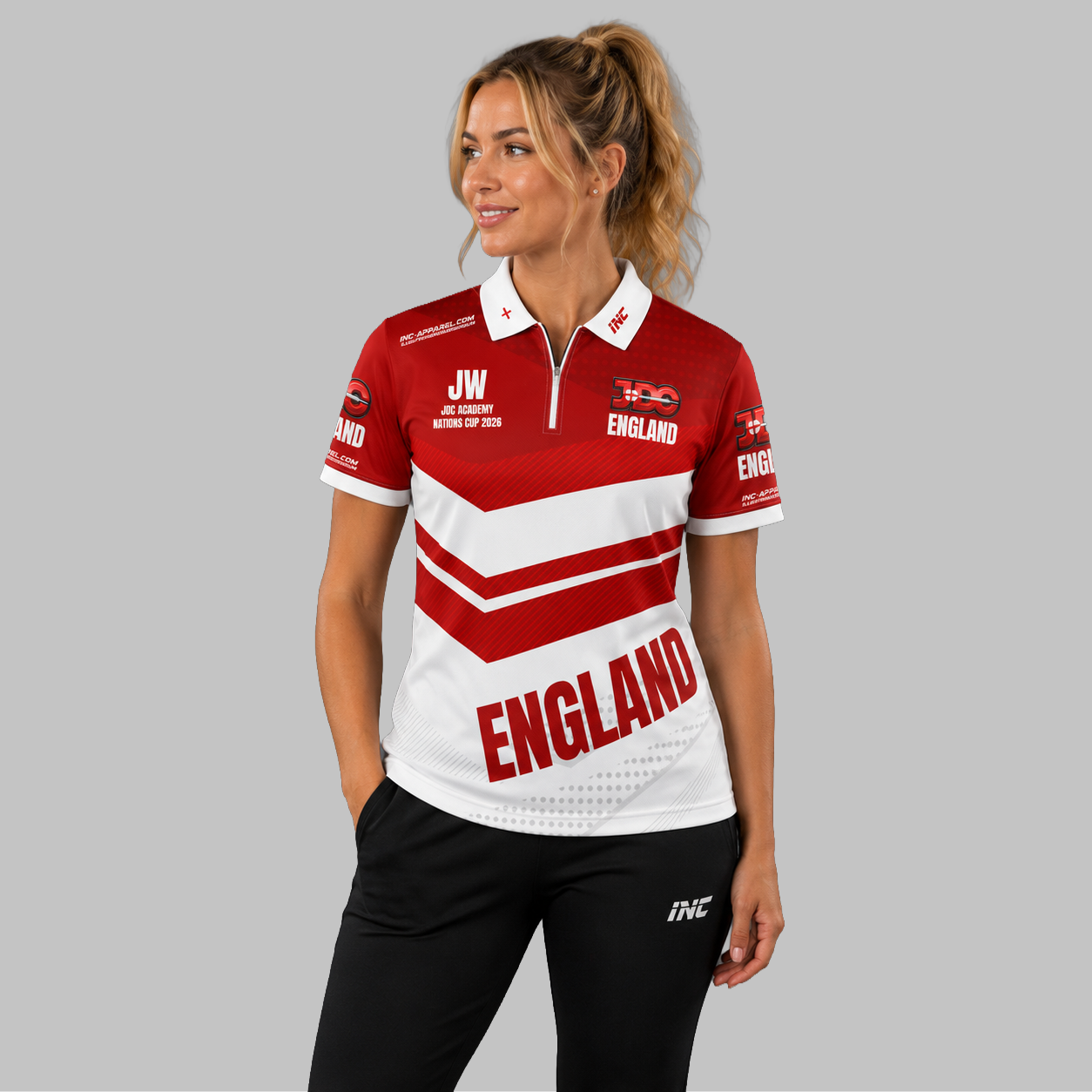 Front view of the Women's Official JDC England Zip Polo Darts Shirt, showing the custom-contoured athletic fit, quarter-zip collar, and prominent team branding.