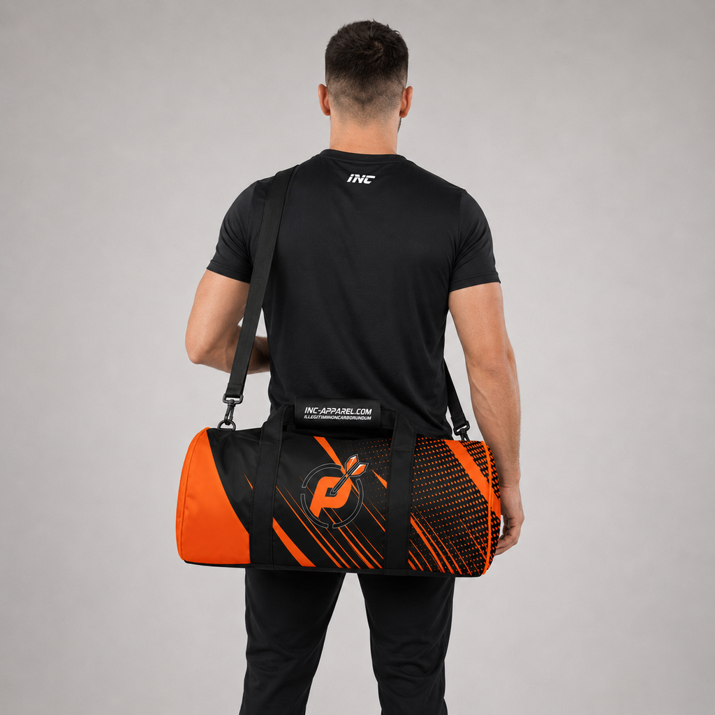 Rear view of a man carrying the Official Prime Sports Darts Academy kit bag, highlighting the adjustable shoulder strap and the padded handle wrap design.