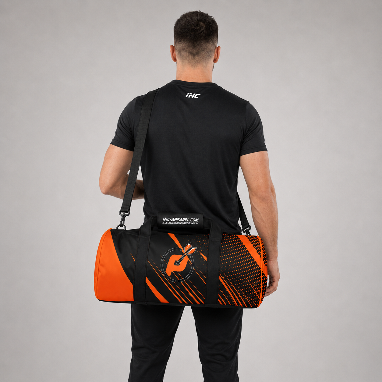 Rear view of a man carrying the Official Prime Sports Darts Academy kit bag, highlighting the adjustable shoulder strap and the padded handle wrap design.