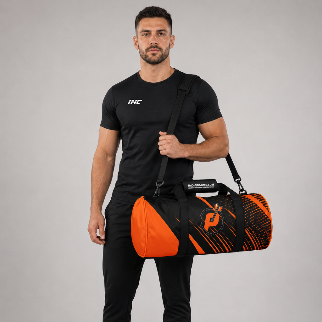 Front view of a man carrying the black and orange Official Prime Sports Darts Academy kit bag over his shoulder, showcasing the official target logo branding.