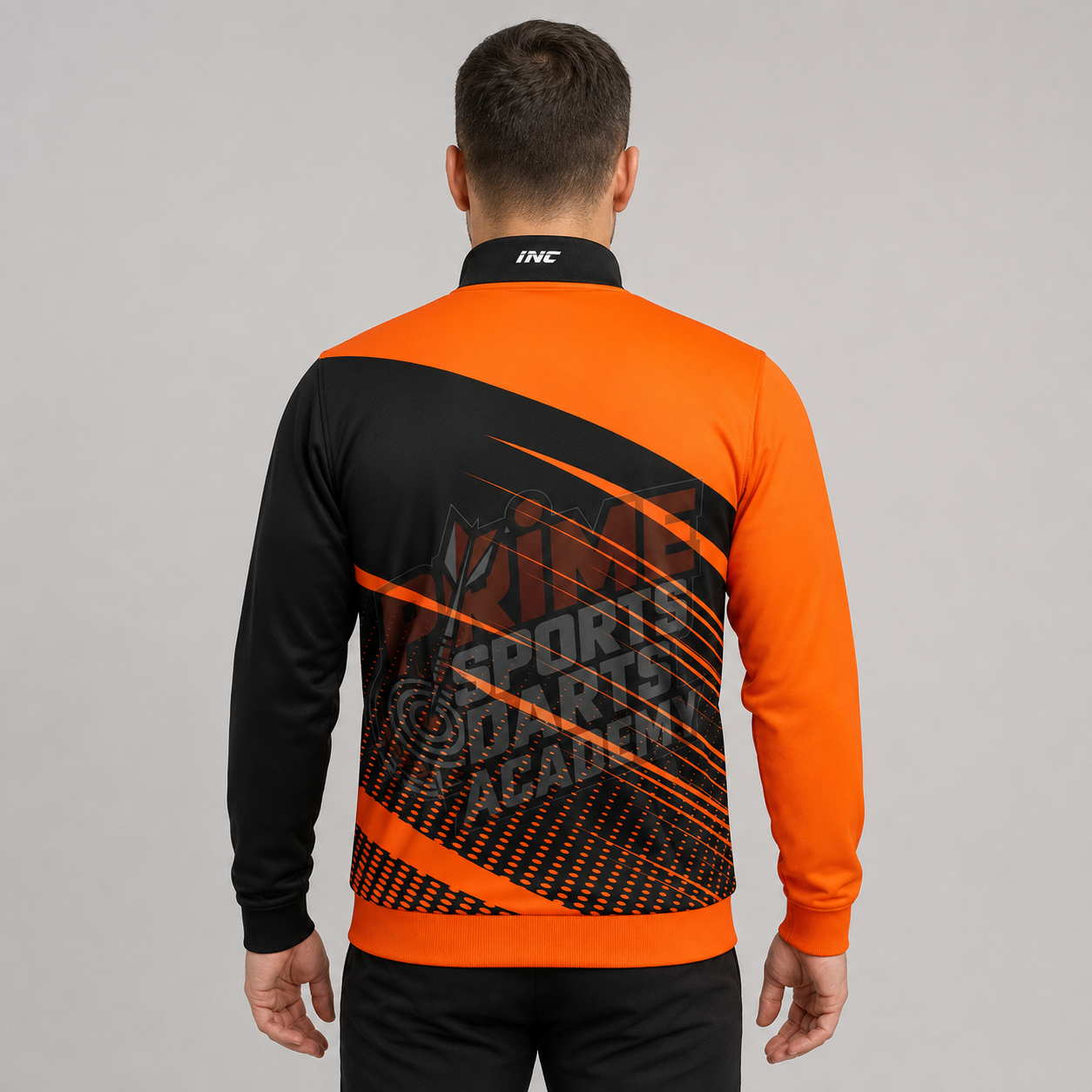 Angled view of the unisex Official Prime Sports Darts Academy Tournament Jacket, showing the elasticated cuffs, high-quality fabric texture, and zippered pocket layout.