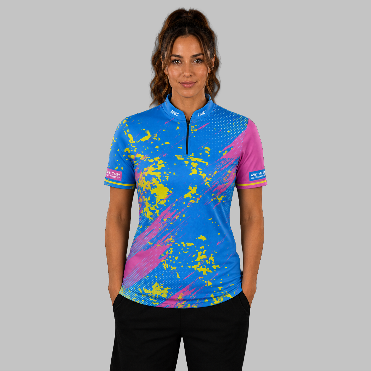 Front view of the Women's Regina blue and pink darts shirt, showing the custom-contoured athletic fit and vibrant sublimated geometric design.
