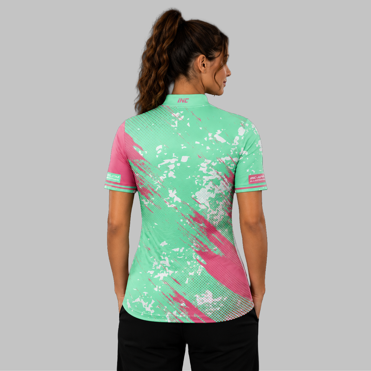 Back view of the Women's Regina green darts shirt, showcasing the seamless flow of the vibrant green graphic pattern across the shoulders.