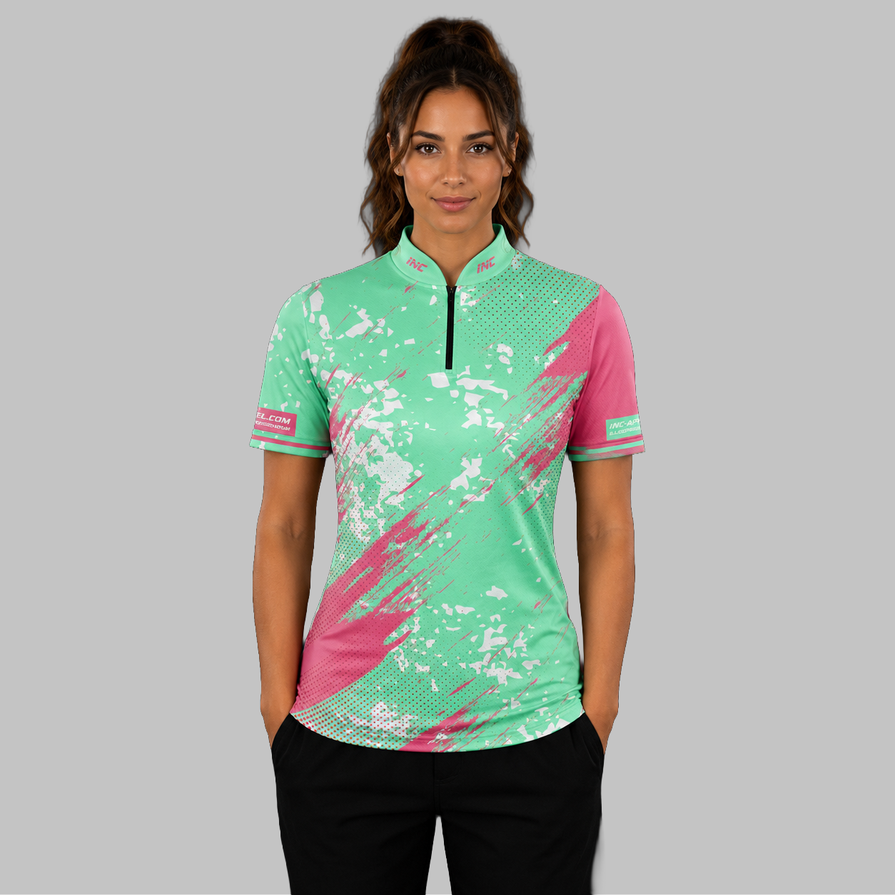 Front view of the Women's Regina green darts shirt, showing the custom-contoured athletic fit and vibrant sublimated geometric design.