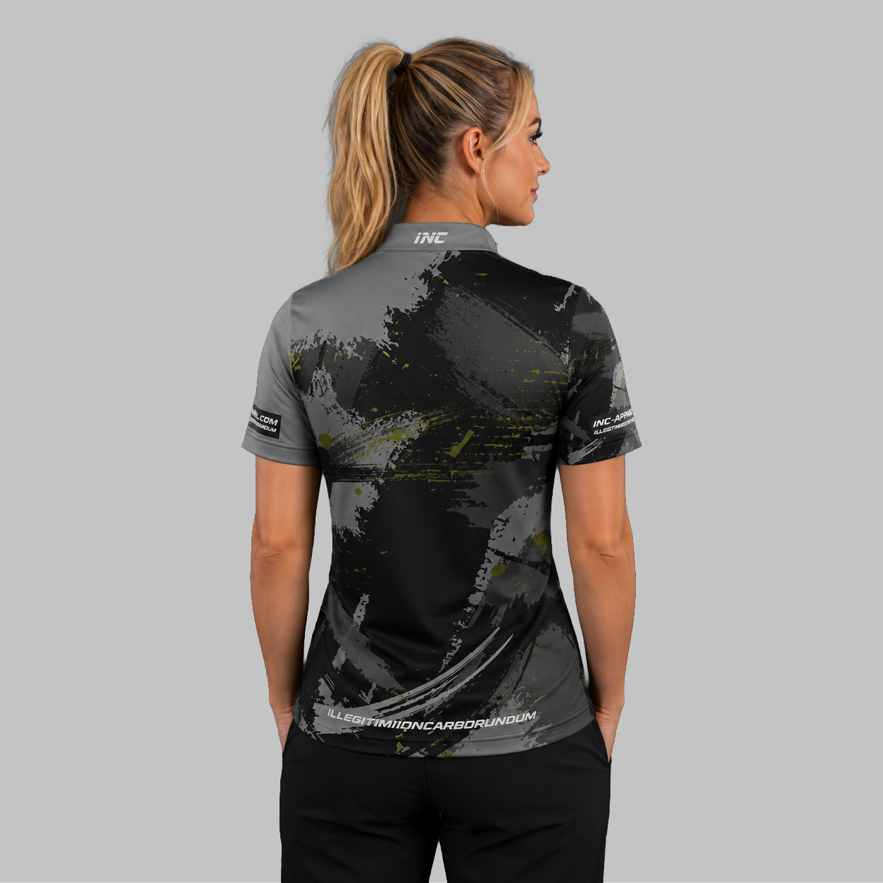 Back view of the Women's Rogatus Umbra darts and pool shirt, highlighting the seamless and clean continuation of the dark graphic pattern across the shoulders.