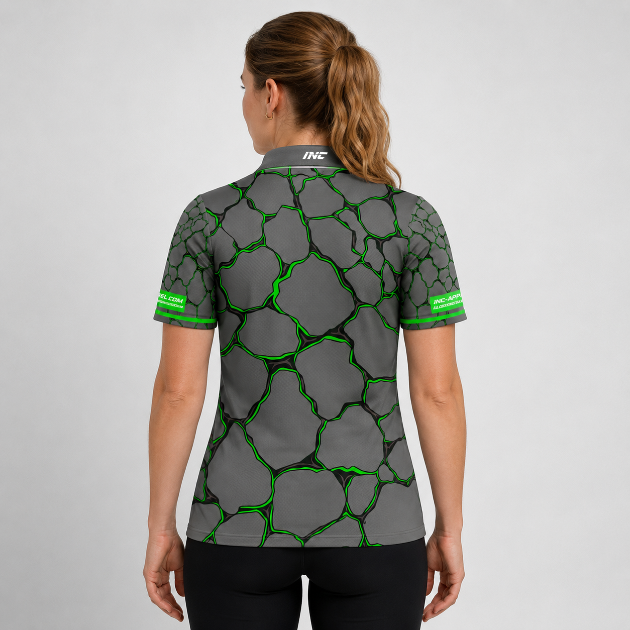 Back view of the Womens Saxosus green darts shirt, showing the clean continuation of the bold graphic athletic pattern across the back.