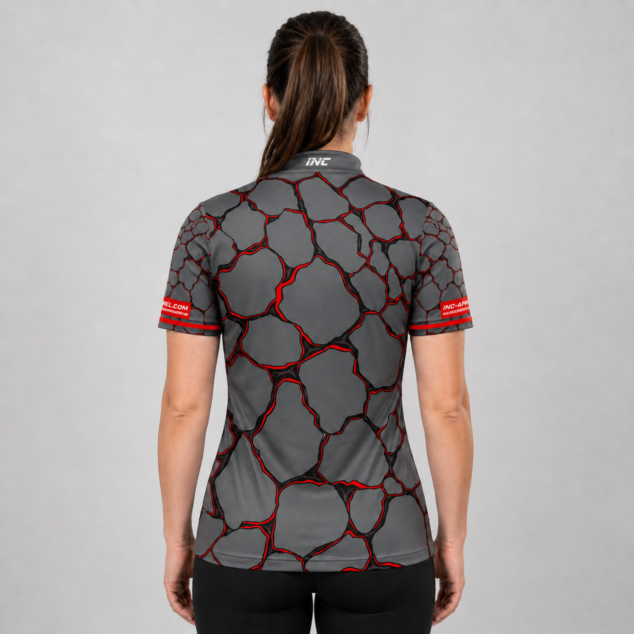 Back view of the Womens Saxosus red darts shirt, showing the clean continuation of the bold graphic athletic pattern across the back.