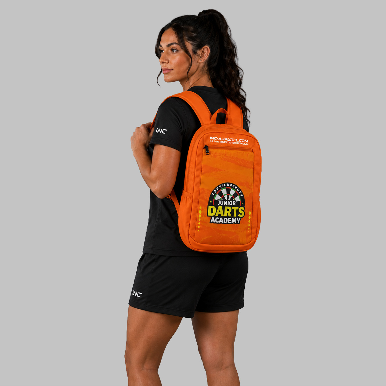 Front view of the Official Carrickfergus Junior Darts Academy backpack, showcasing the durable technical layout and prominent academy branding.