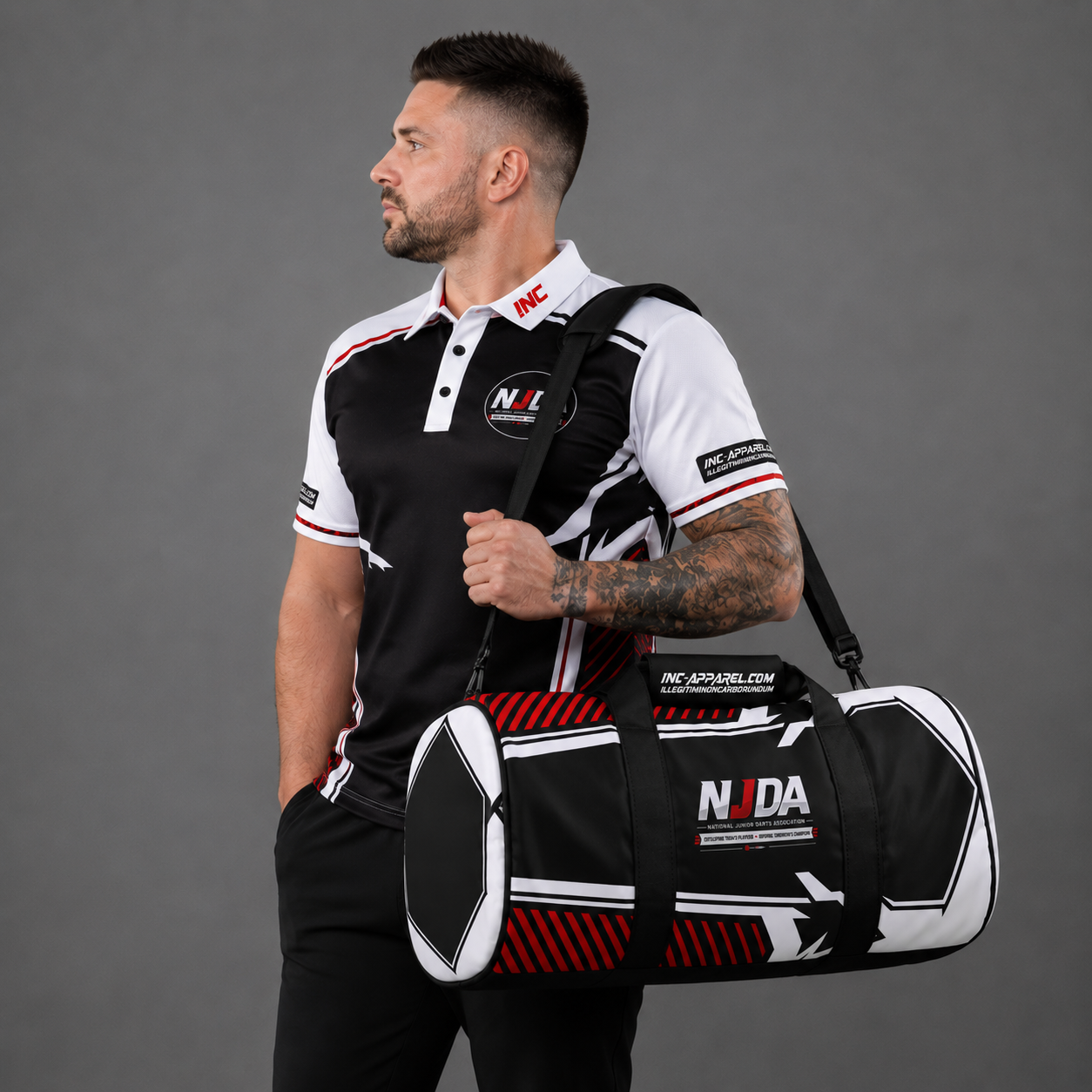 Official National Junior Darts Association sports duffel kit bag in black, displaying the printed NJDA logo, reinforced handles, and separate side zipped compartments.