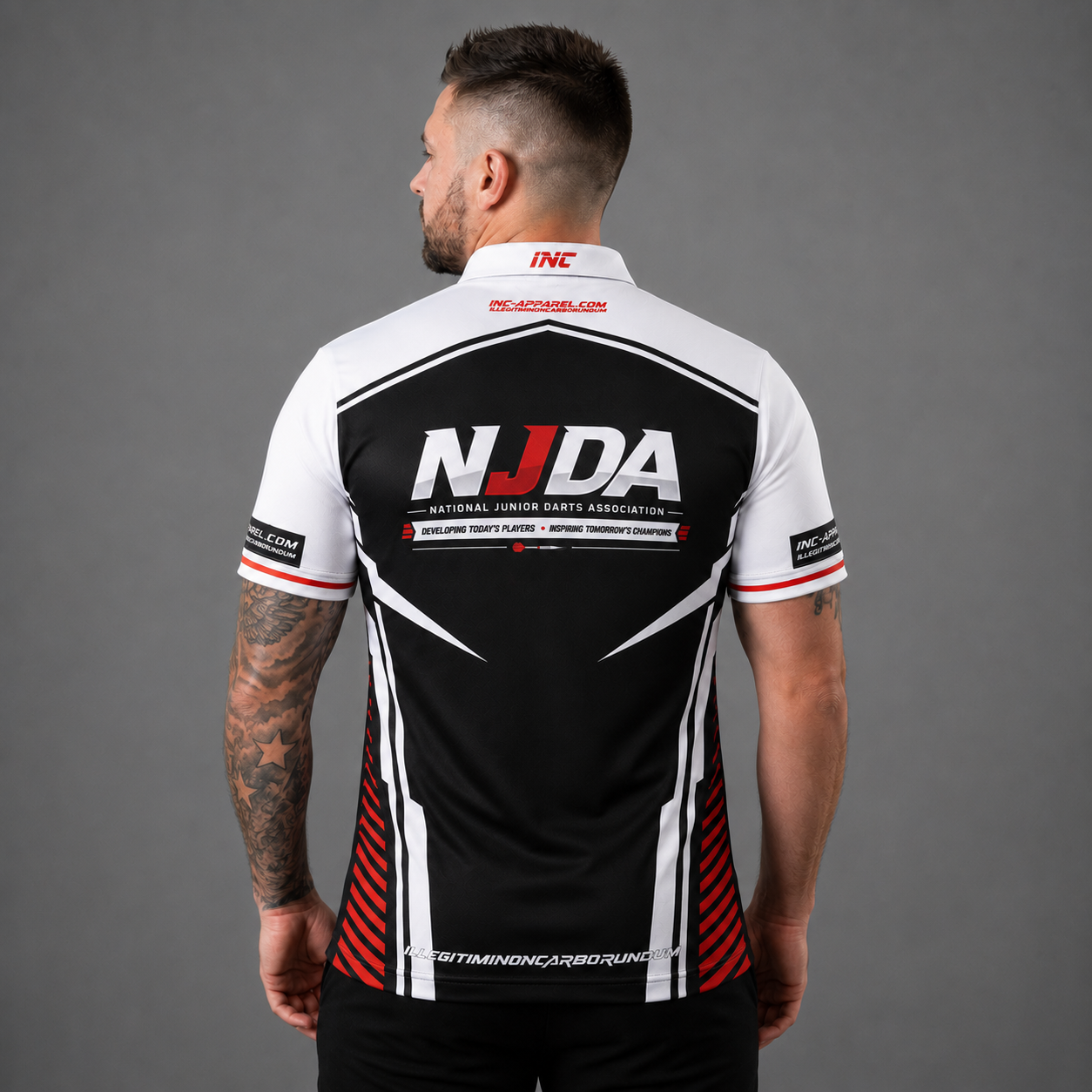 Official National Junior Darts Association darts teamwear shirt back featuring the NJDA logo, shown in men's and youth sizes.