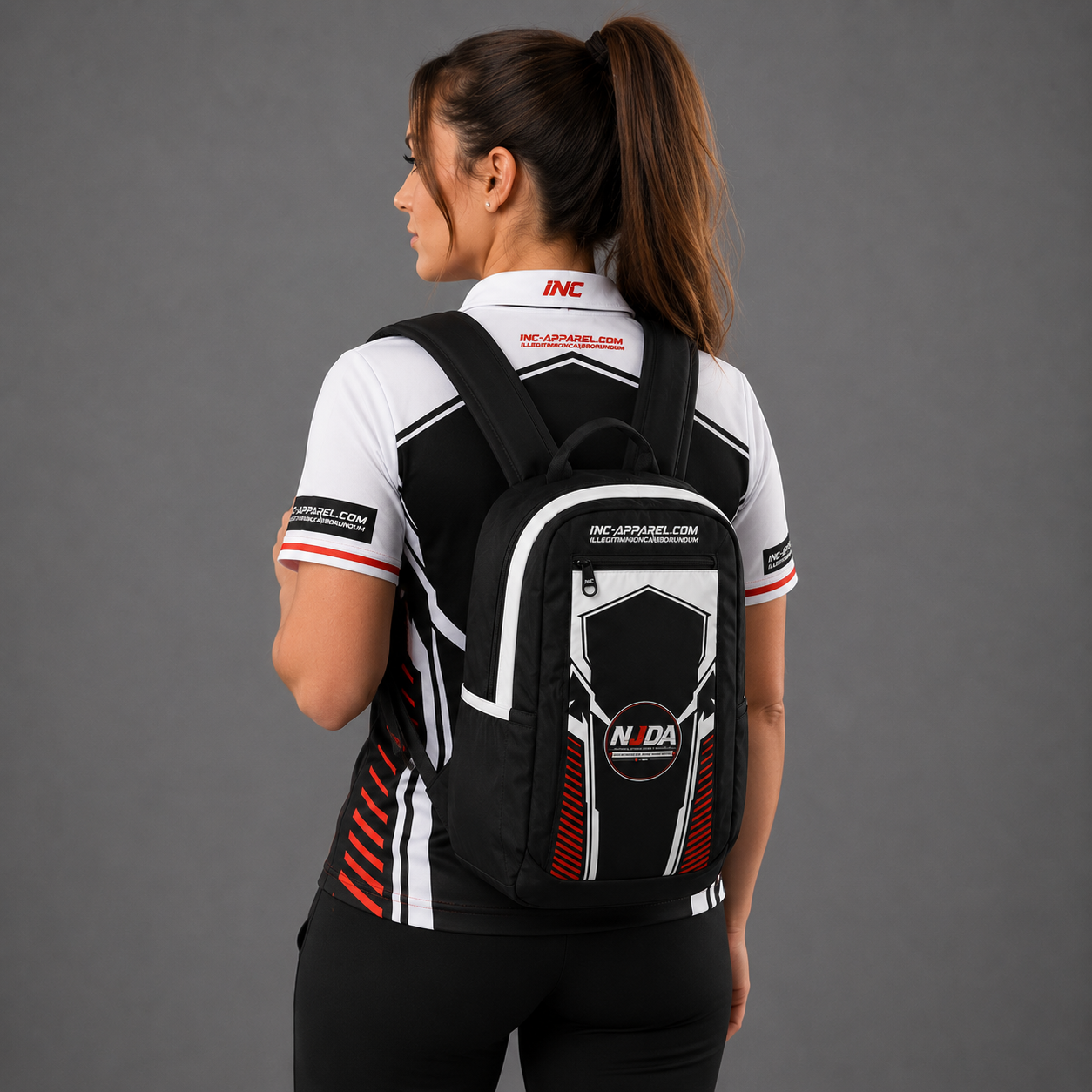 Official National Junior Darts Association tournament backpack in black featuring the embroidered NJDA league logo, padded straps, and zipped storage compartments.